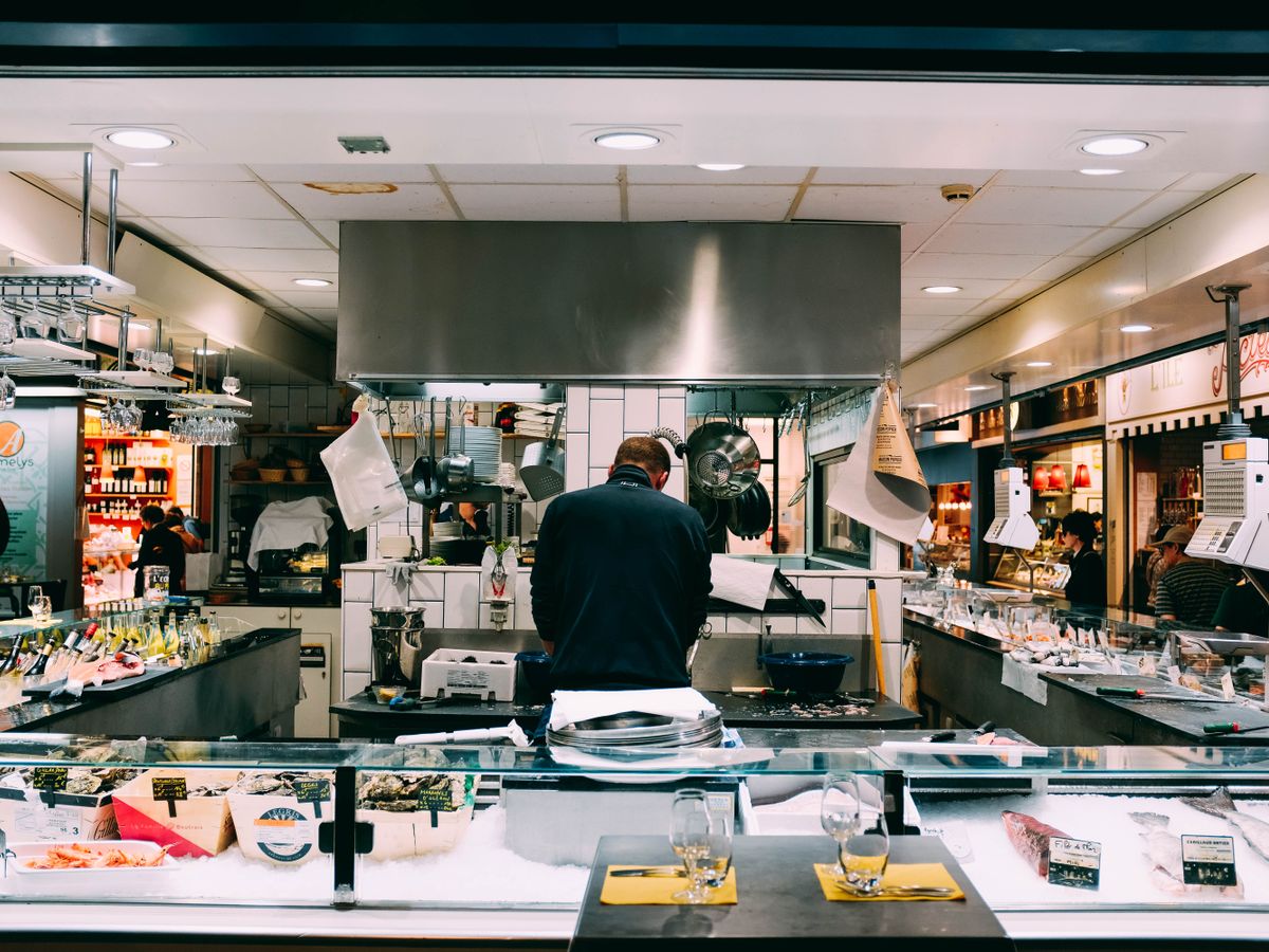 Warm heat lamps over the pass in a restaurant kitchen